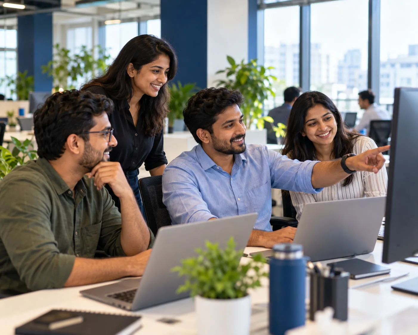 A small software team working together at a desk